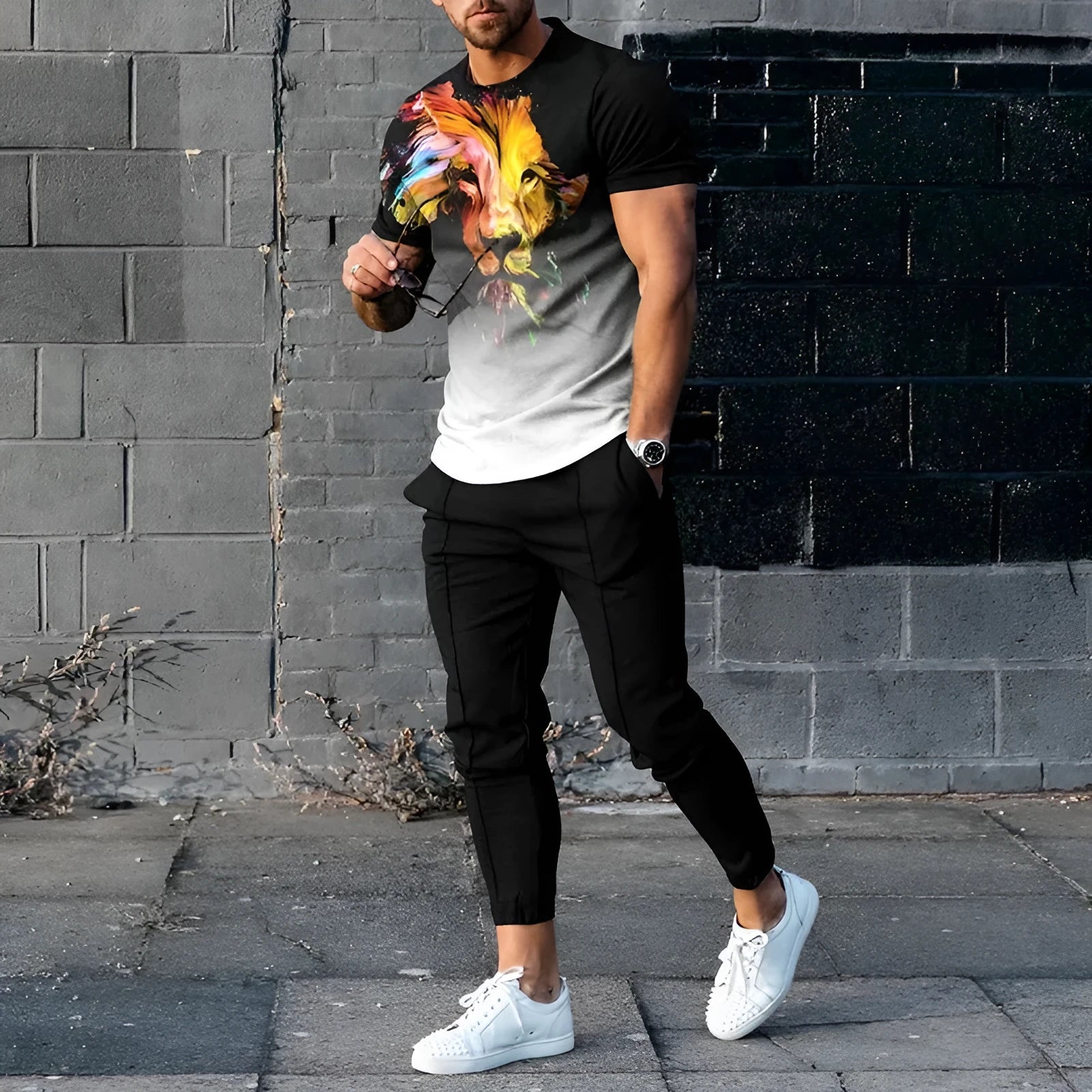 Man modelling a short-sleeved printed pullover and matching trousers from a lightweight polyester sports suit set.