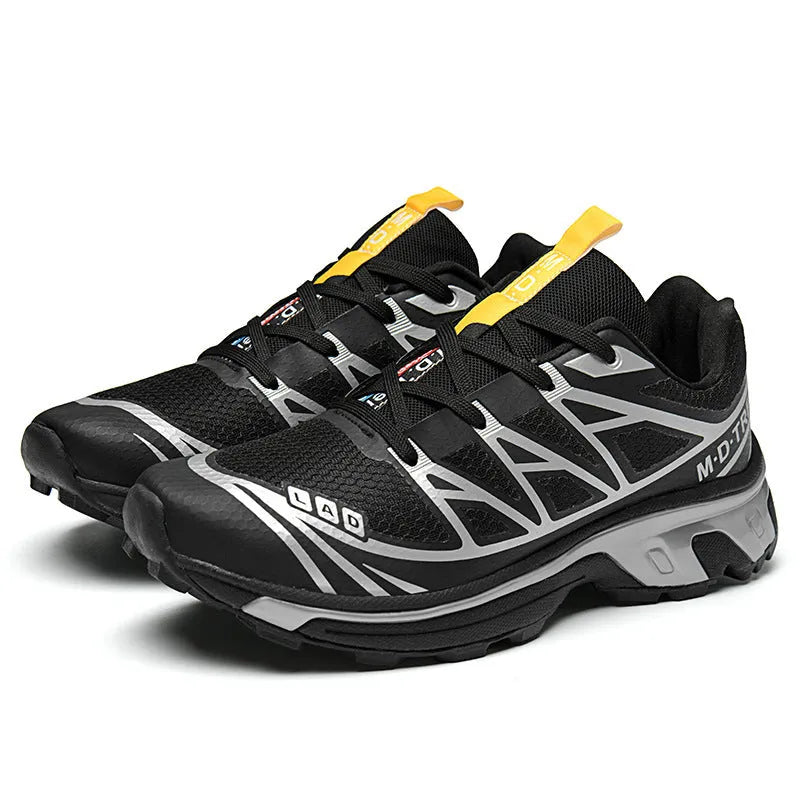Men's and women's low-top artificial leather hiking shoes in multiple colours with flat rubber sole and lace-up front.