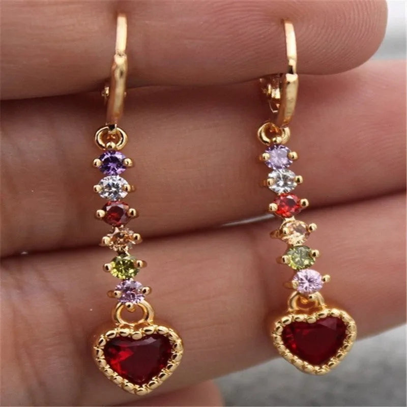 A pair of women's heart-shaped drop earrings with a gold electroplated finish.