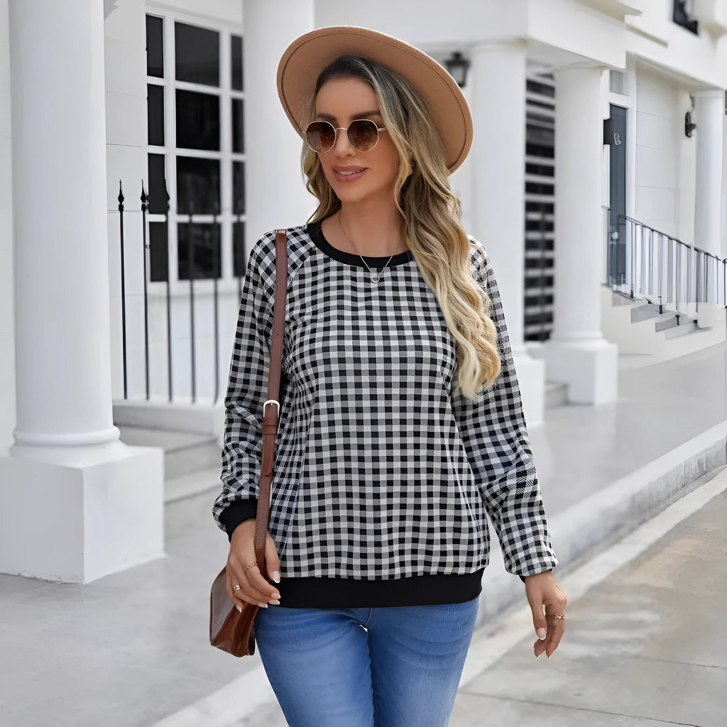 Black Japanese plaid pattern long sleeve pullover sweater on a hanger.