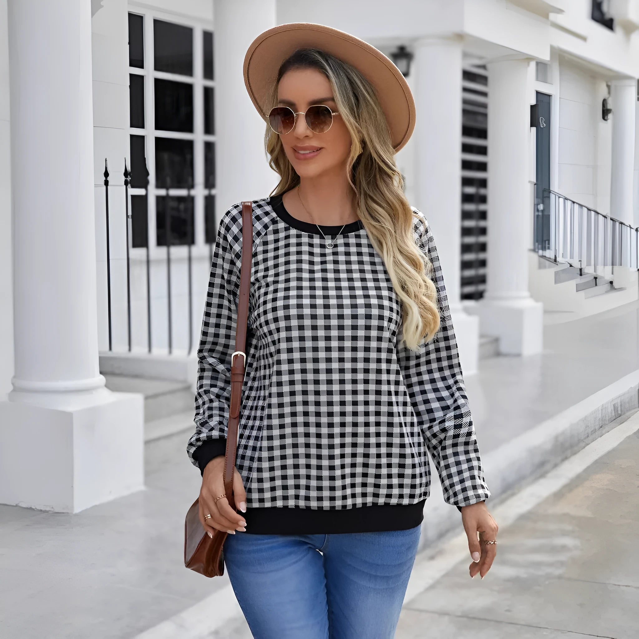 Black Japanese plaid pattern long sleeve pullover sweater on a hanger.
