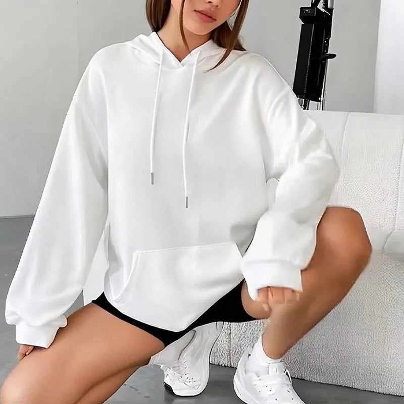 Loose grey women's sweatshirt with a drawstring waist and long sleeves on a hanger.