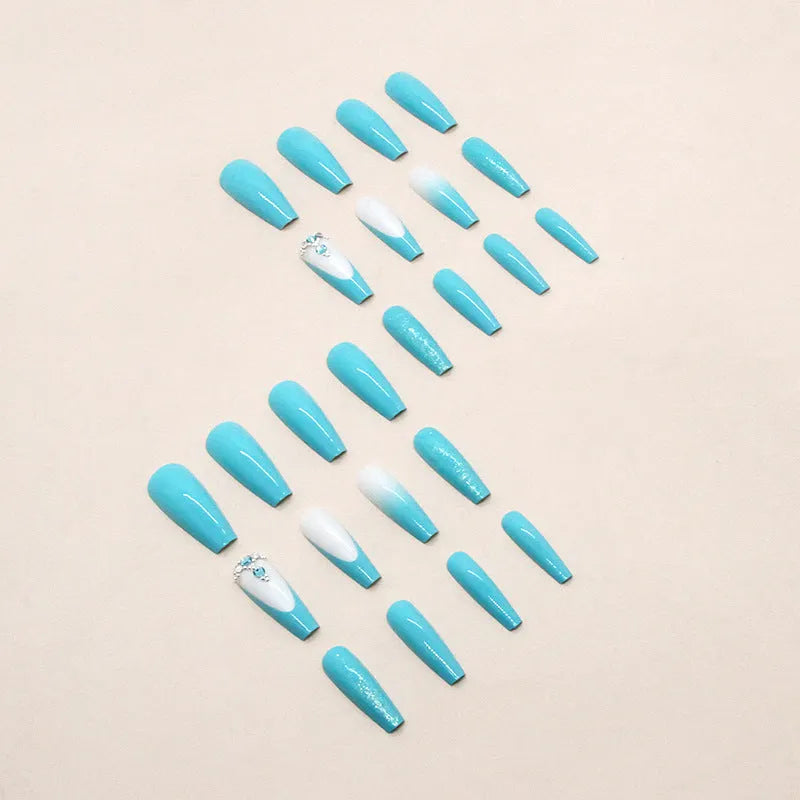 Long ballet artificial nails in smart blue diamond colour with glitter debris particles