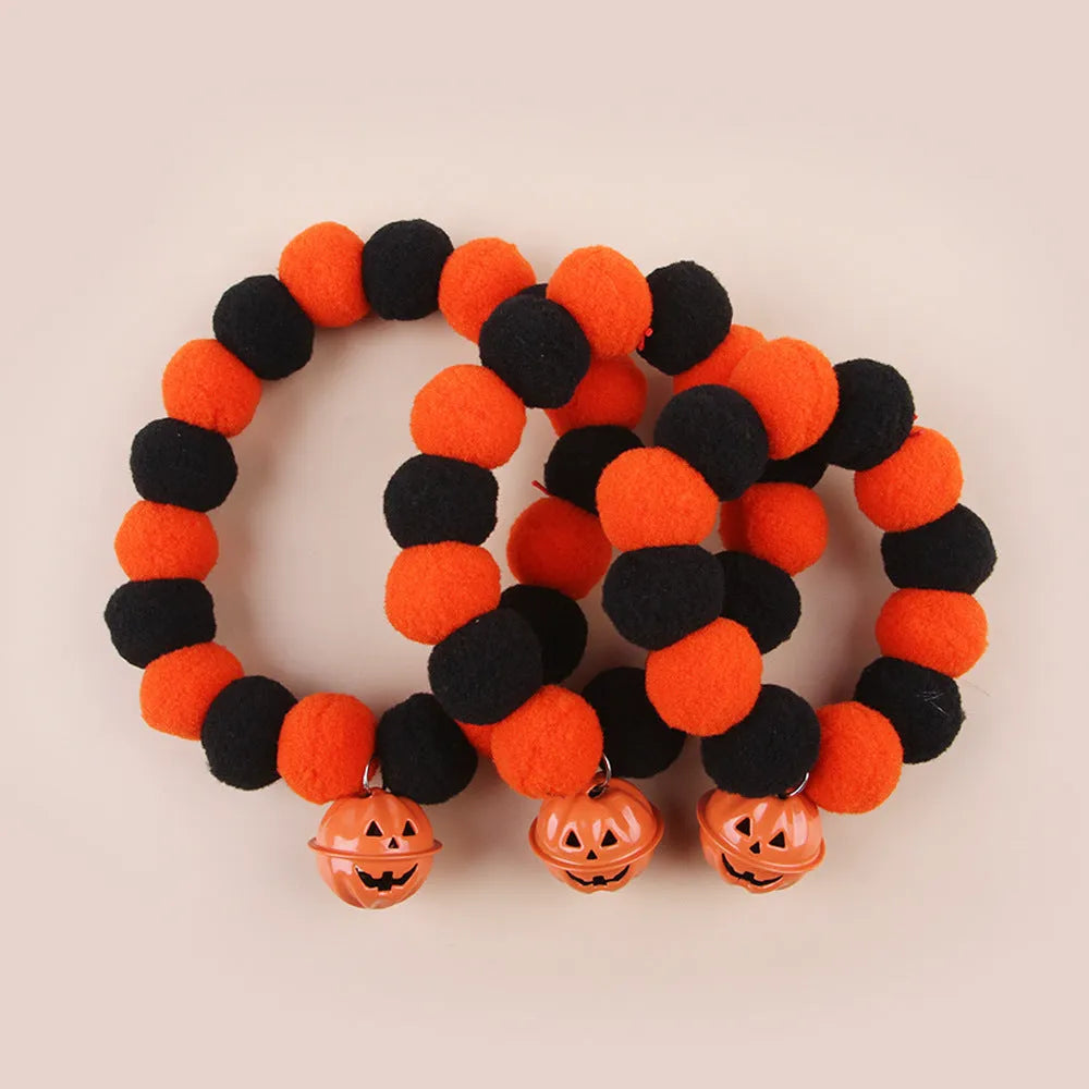 Orange Halloween pumpkin cat collar with green leaf on a breakaway safety buckle.