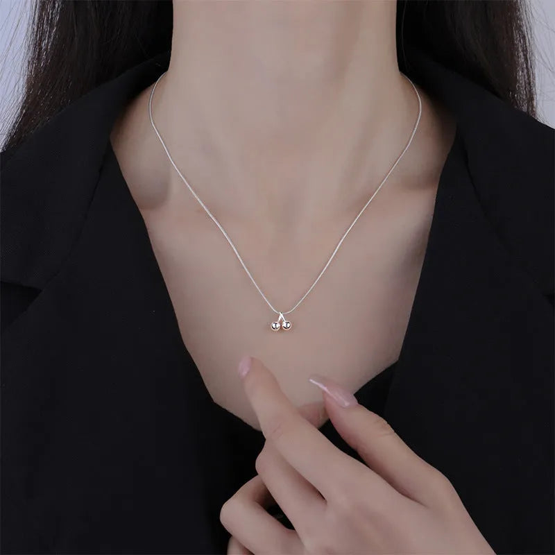 Silver cherry necklace for women with fruit pendant on a snake bone chain, adjustable length.