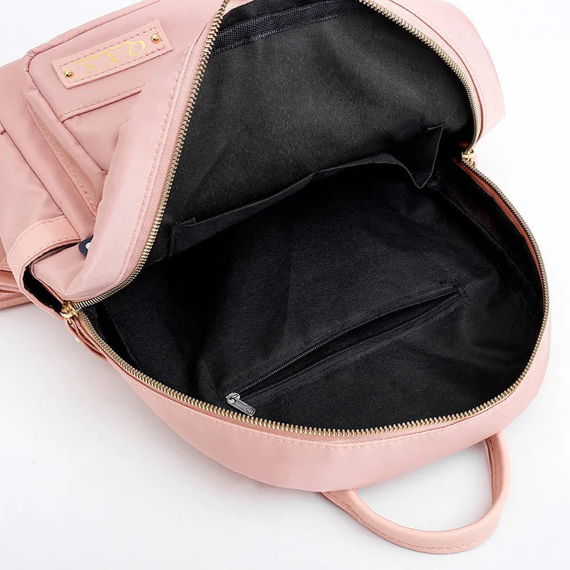 Women's nylon casual backpack in black with double shoulder straps and front pocket