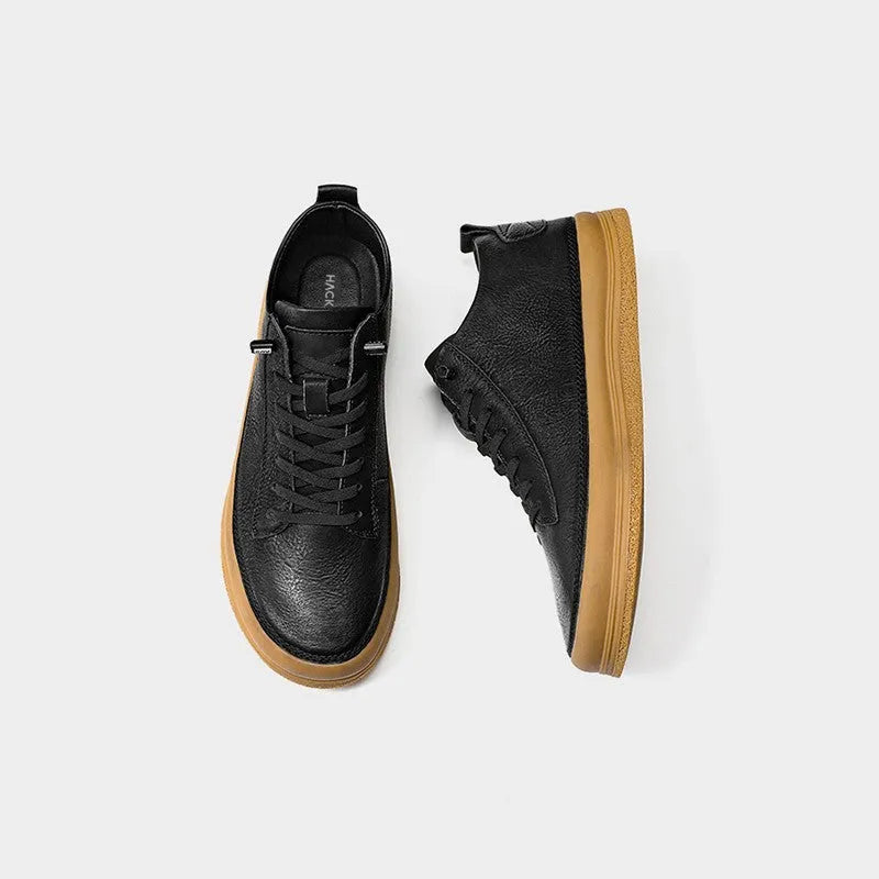 Men's black leather casual shoes with round toe, flat heel, and white laces on a rubber sole.