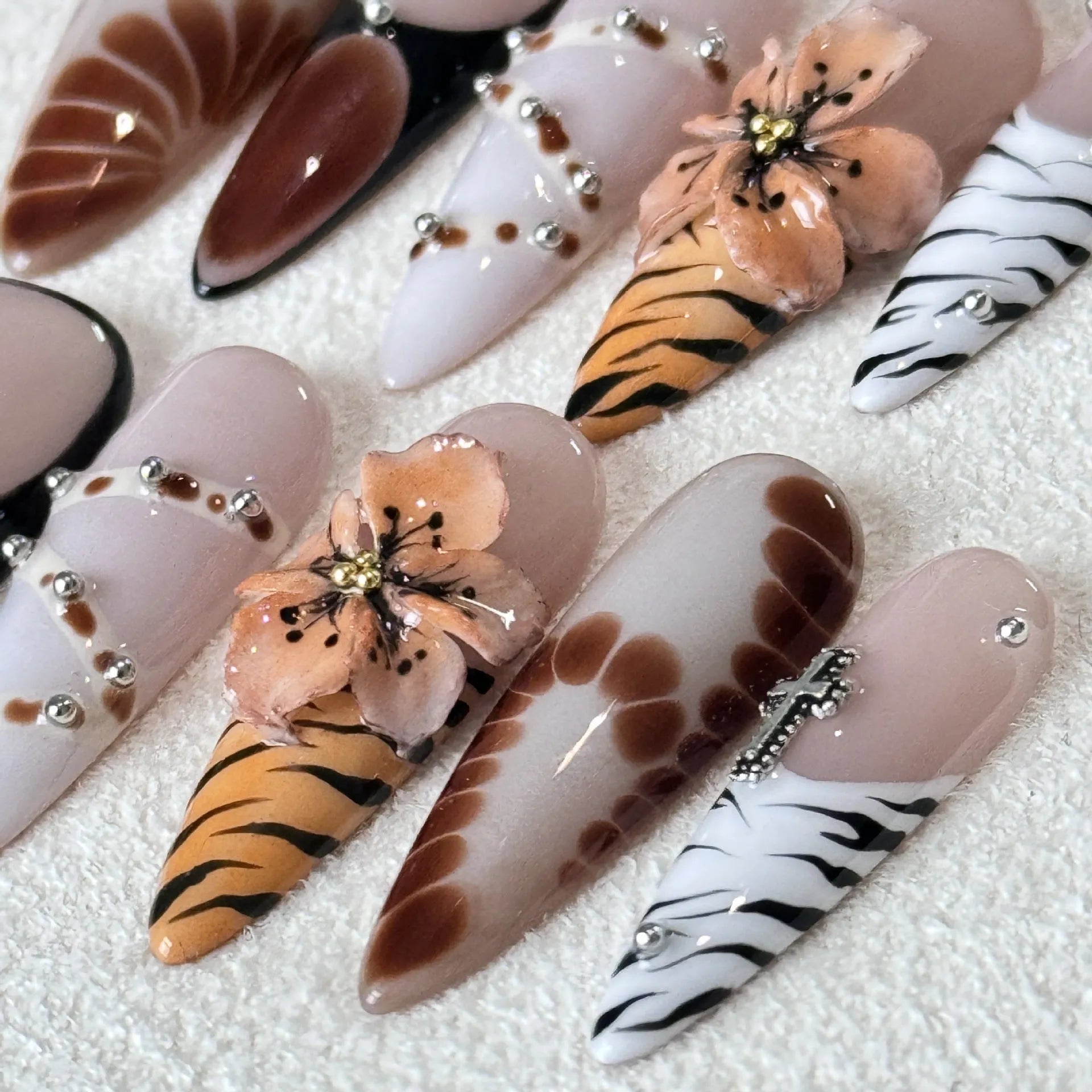 Handmade gel nail stickers with leopard, cross, and flower prints in a pack of ten.