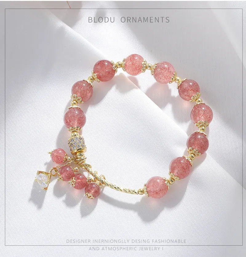 Pink women's bracelet with heart-shaped strawberry quartz crystals and pearl bead accents on adjustable band