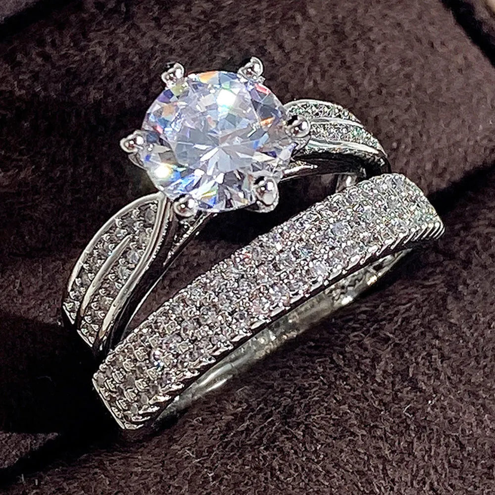 White gold colour geometric alloy wedding ring on a finger, showing its simple round band design.