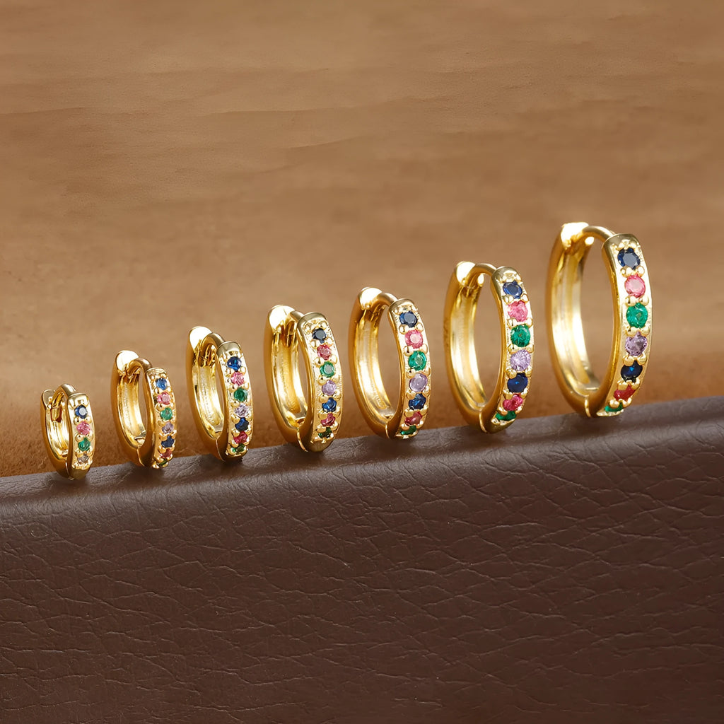 A pair of round perforated circle zircon stud earrings in gold, rose gold, and silver colour options.