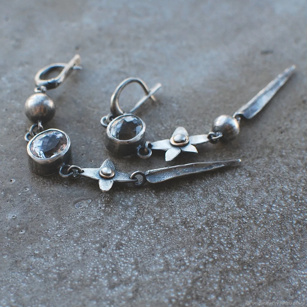 Geometric antique silver earrings with rhinestone accents and XINGX pendant design