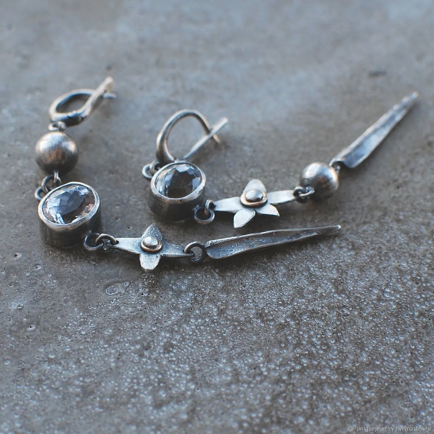 Geometric antique silver earrings with rhinestone accents and XINGX pendant design