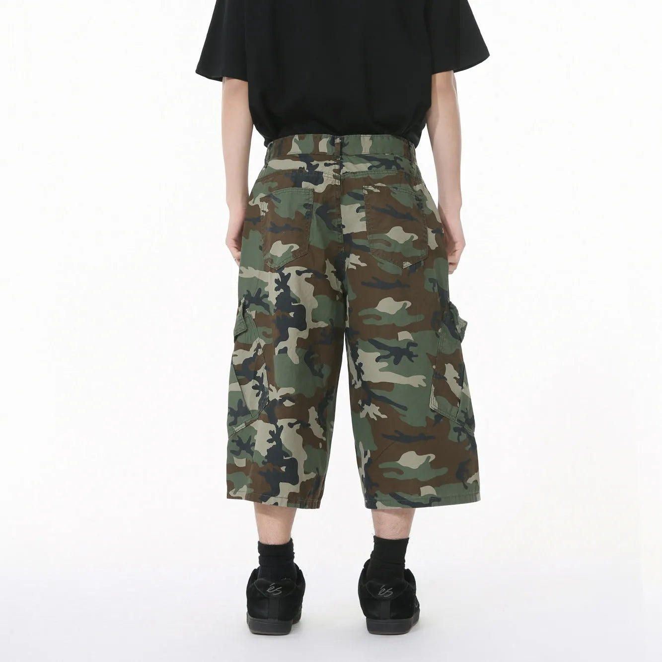 Men's loose fit camouflage cotton jeans with wide legs, cropped length, and a large side pocket.