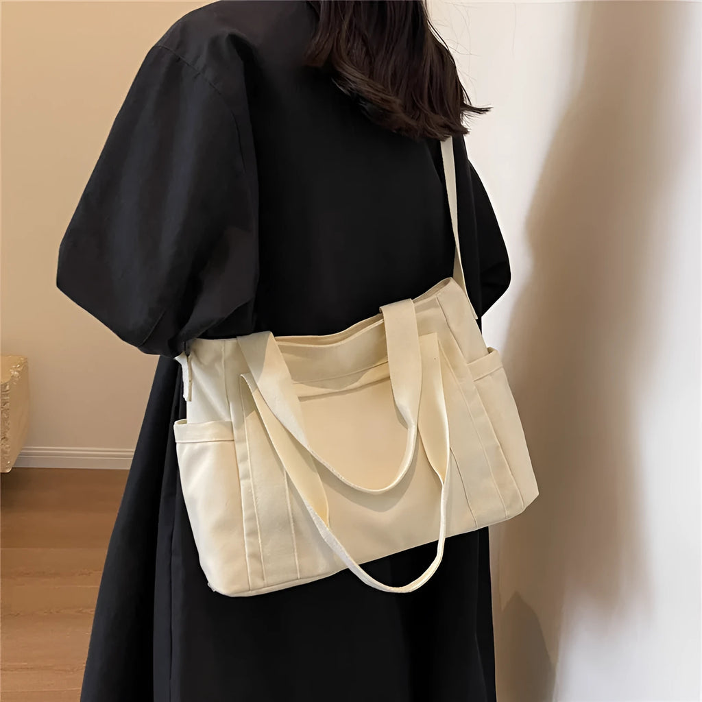 Large solid colour polyester canvas shoulder tote bag for women with internal mobile phone pocket.