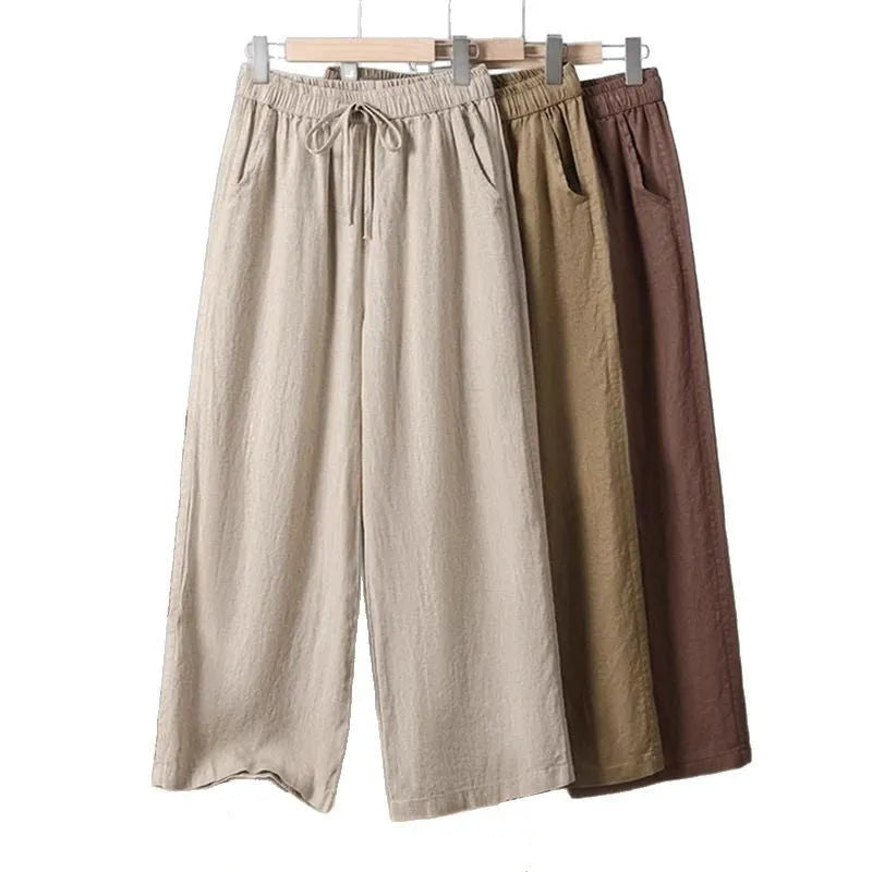 Women's apricot straight-leg casual trousers with elastic waist and lace-up detail.