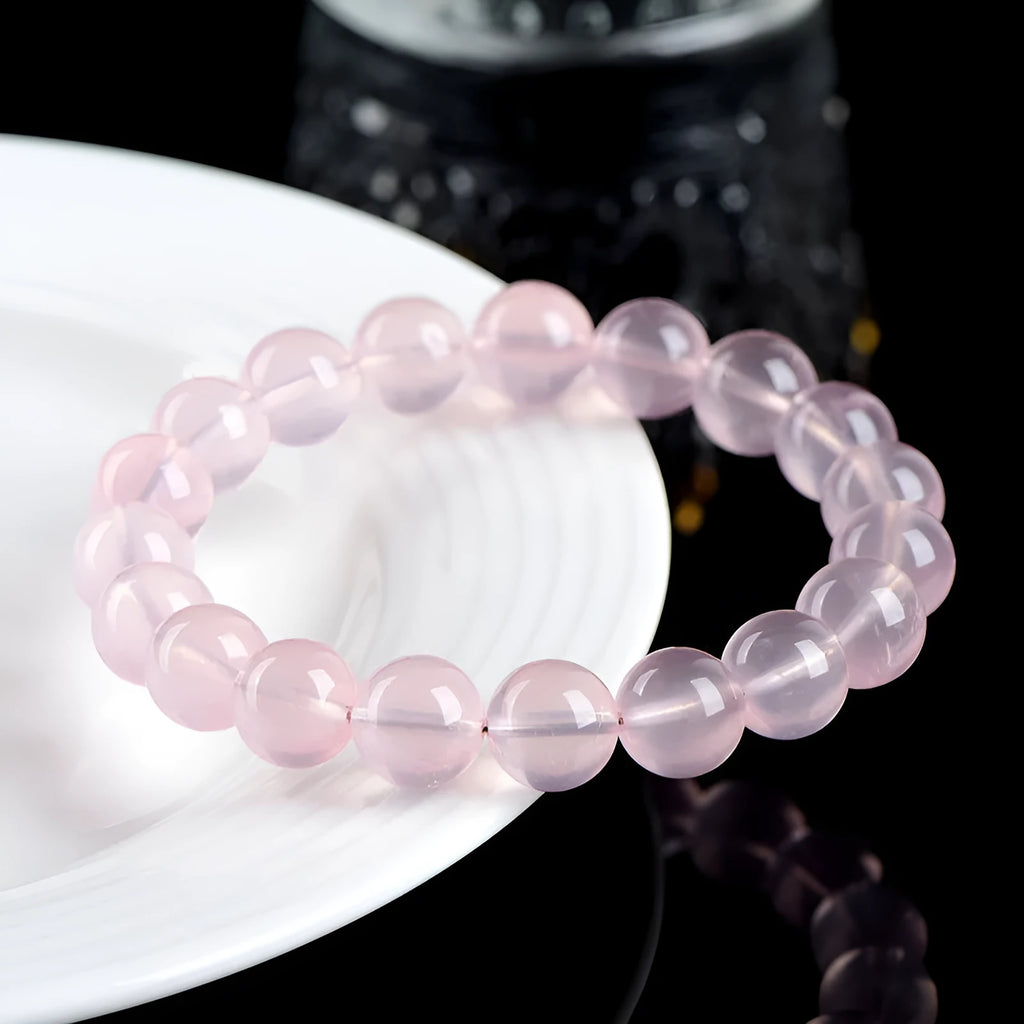 Women's natural starlight crystal bracelet with polished round pink beads in single circle configuration