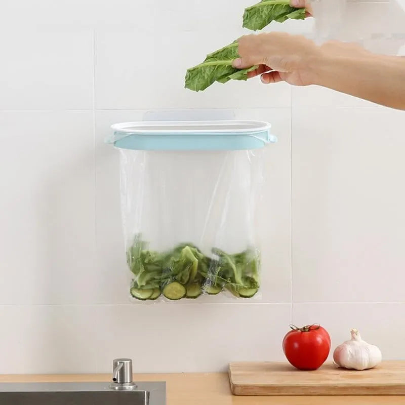 Blue kitchen plastic garbage bag storage rack on a cabinet door.