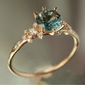 Gold plated geometric claw ring with a zircon stone, showing chamfered square pattern on band.