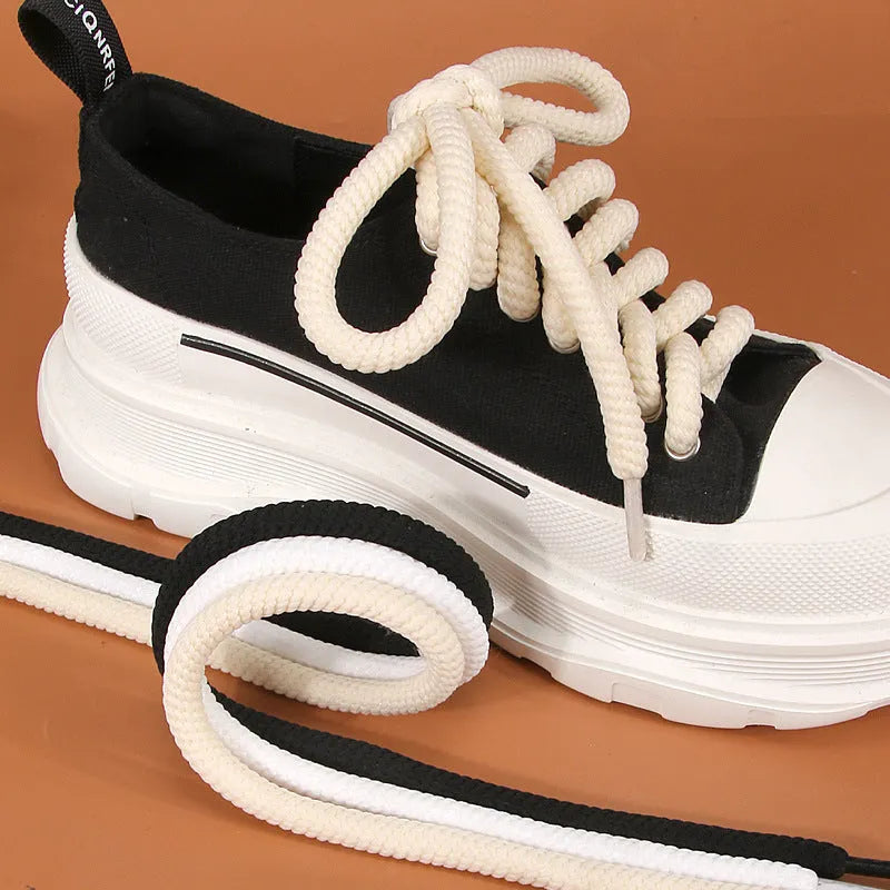 Round woven shoelaces for Bread Shoes in white, beige and black colours on a white background.