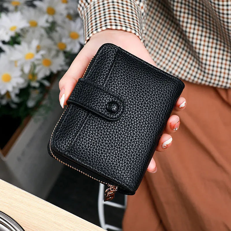 Women's Lychee pattern organ short wallet in breathable antibacterial PU, shown in beige, pink, black, and red colour options.