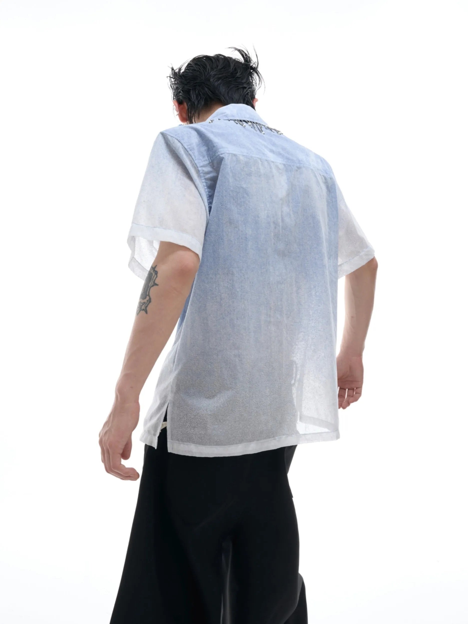 Man wearing a loose-fit gradient blue short-sleeved polyester casual shirt.