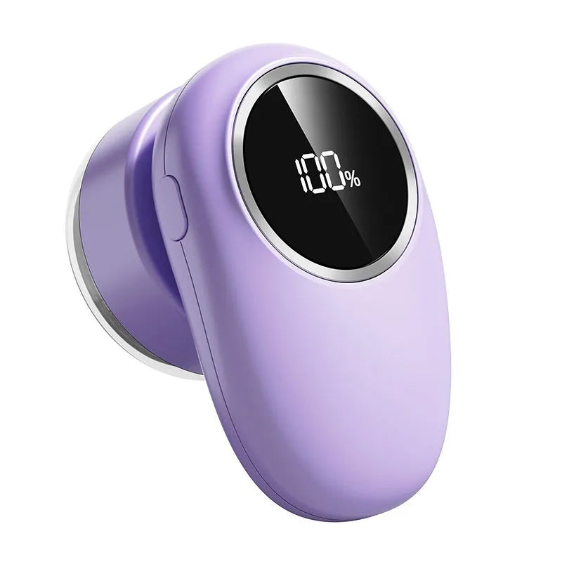 Purple and beige digital fur ball trimmer with LED display and multiple replaceable cutter heads on a fabric sofa.