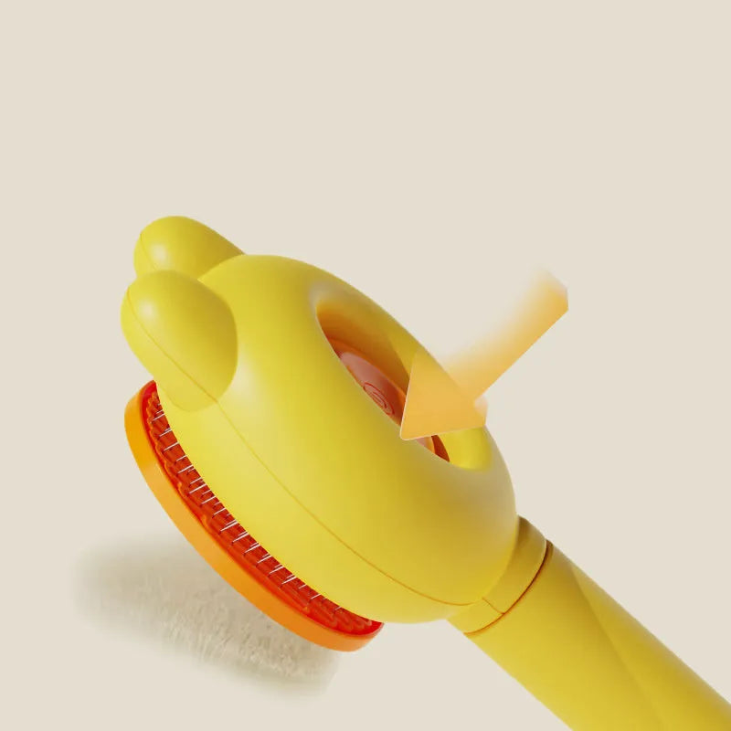 Green pet grooming brush with a release button and stainless steel teeth on a non-slip handle.