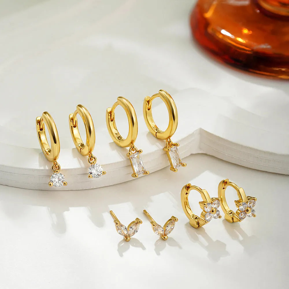 Copper geometric earring set with zircon details in gold or silver electroplated finish showing star, ellipse, ring and quadrilateral designs