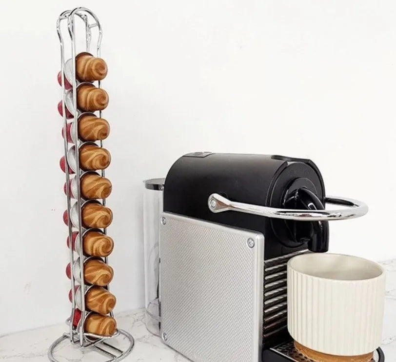 Wrought iron coffee capsule storage rack holding pods, in black or silver finish.