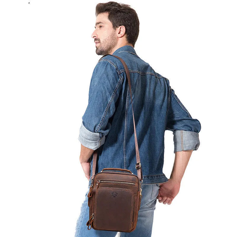 Men's brown genuine leather crossbody bag with single shoulder strap and visible stitching