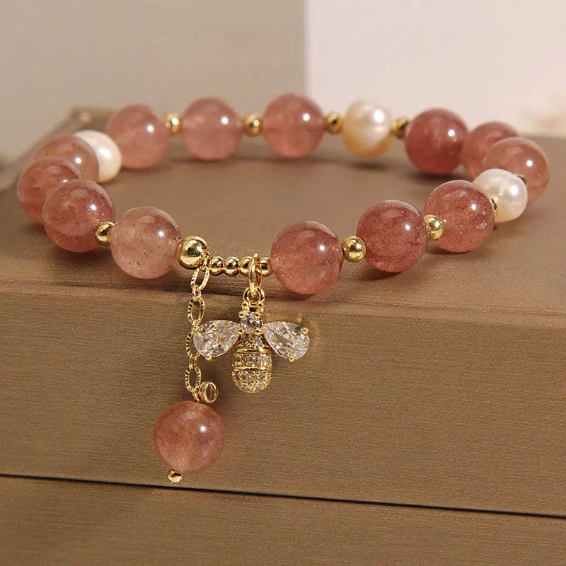 Women's bracelet with freshwater pearls, strawberry quartz beads, zircon accents, and an alloy clasp.