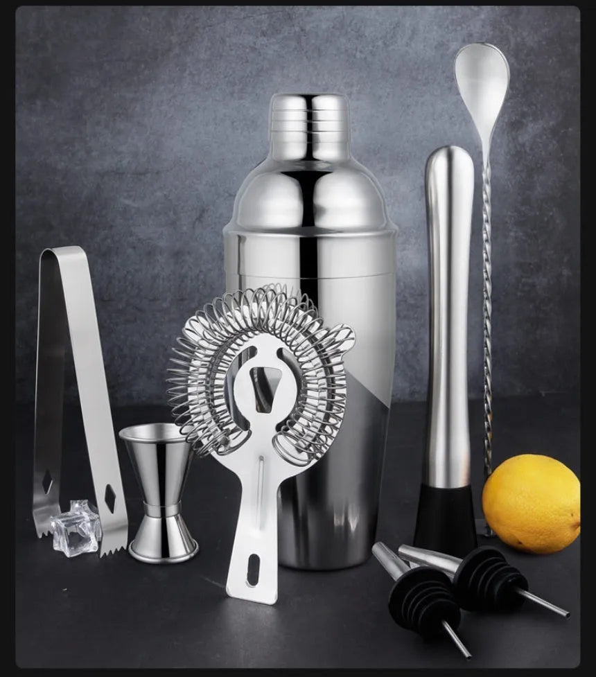 23-piece stainless steel cocktail set with acrylic mixing components on bar counter
