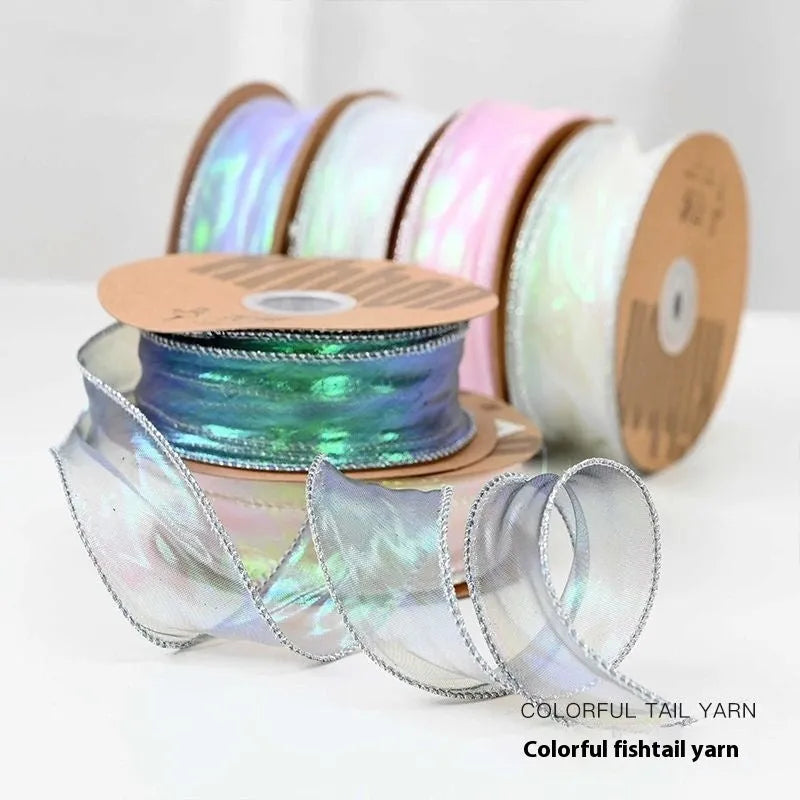 Colourful 4cm fishtail yarn craft ribbon on roll showing textured mesh construction