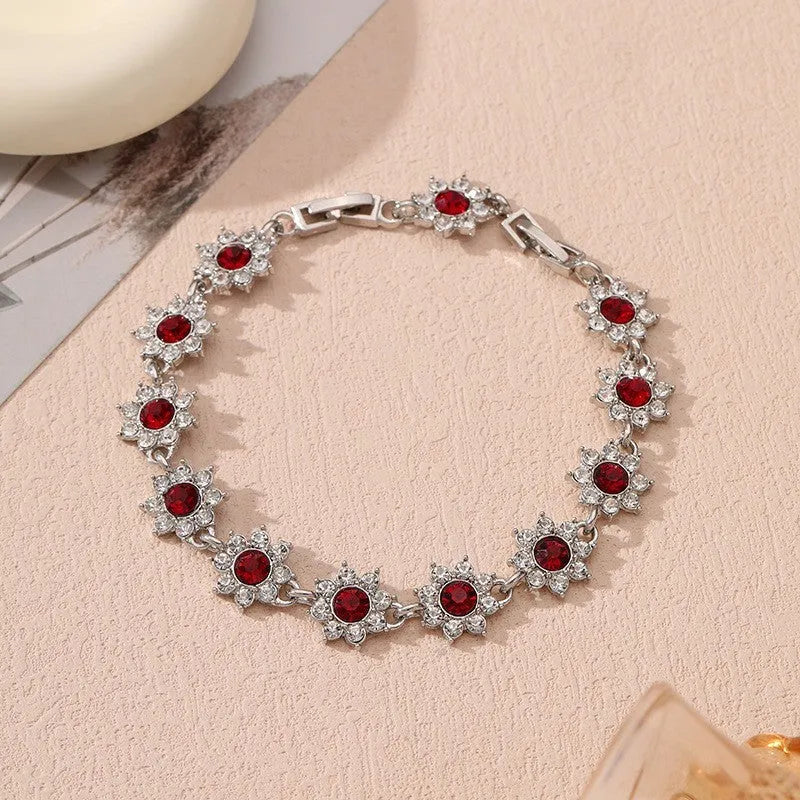 Gold and silver tone zinc alloy flower bracelet with electroplated coloured gemstones including crystal and diamond accents.