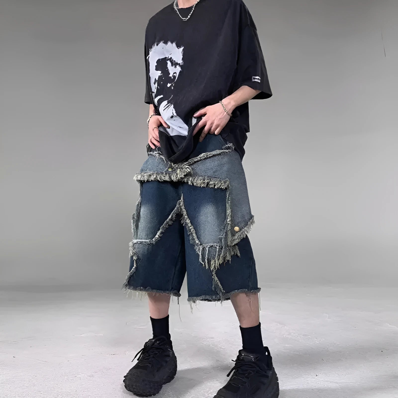 Blue denim shorts with a frayed five-pointed star detail on the leg, showing a loose, retro fit.