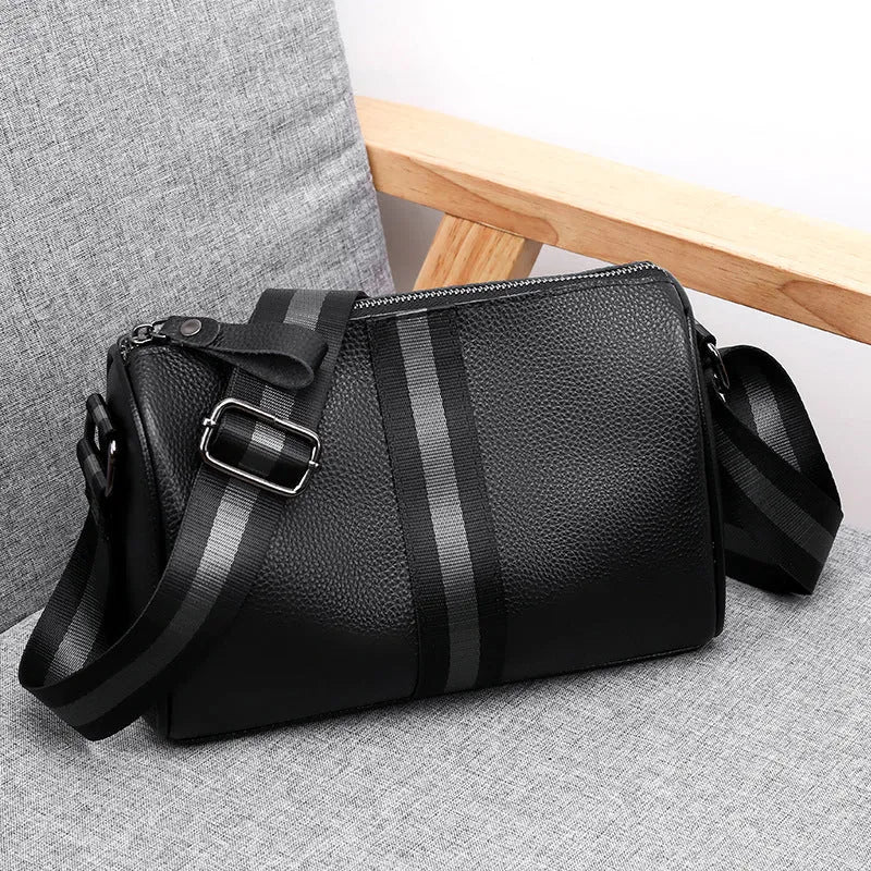 Black genuine leather women's crossbody bag showing front view and shoulder strap