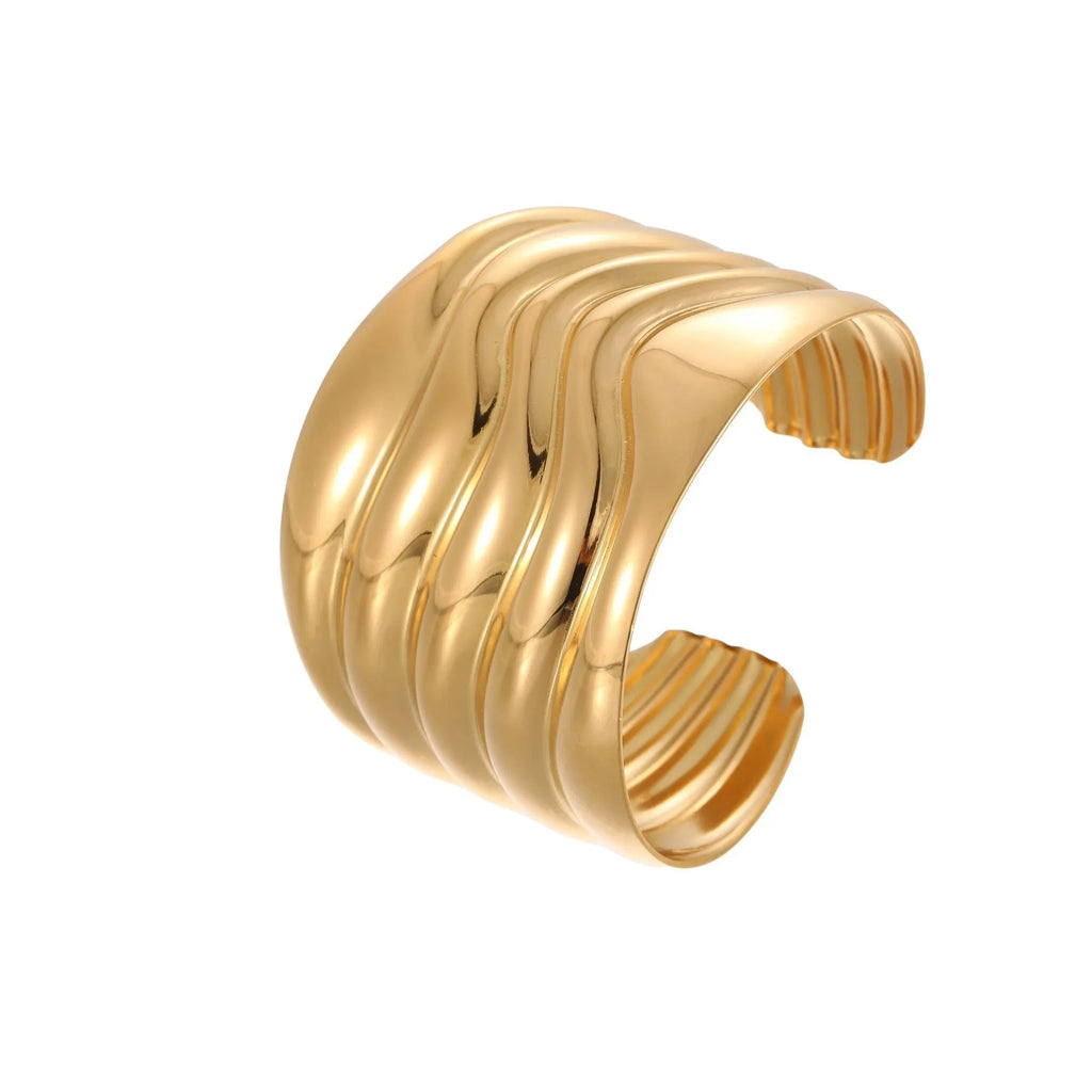 Women's wide stainless steel bracelet with gold plating and wave geometric pattern