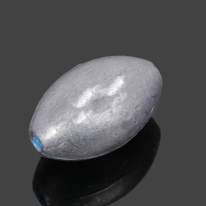 Rugby-shaped olive lead fishing sinker with scale texture pattern and plastic core construction