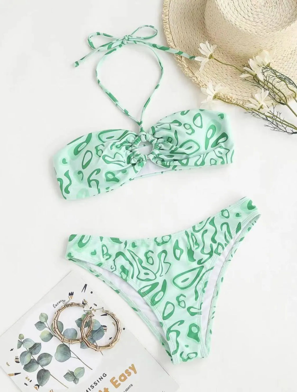 Women's blue floral bandeau bikini swimsuit with split style design on mannequin