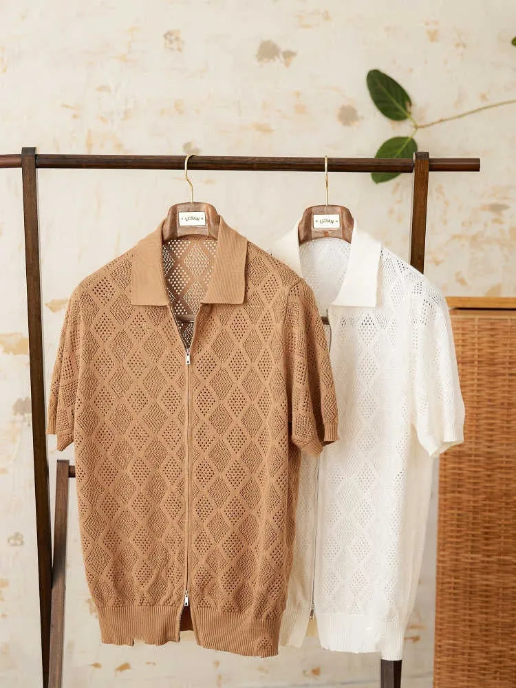 Front view of a white cotton cardigan with a zipper and lapel collar.