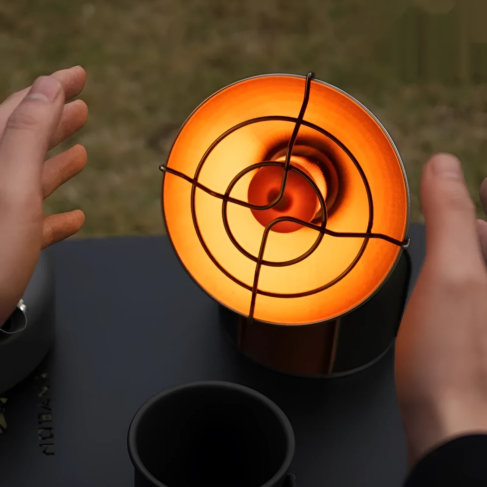 Portable outdoor heating stove with black and orange design and automatic ignition