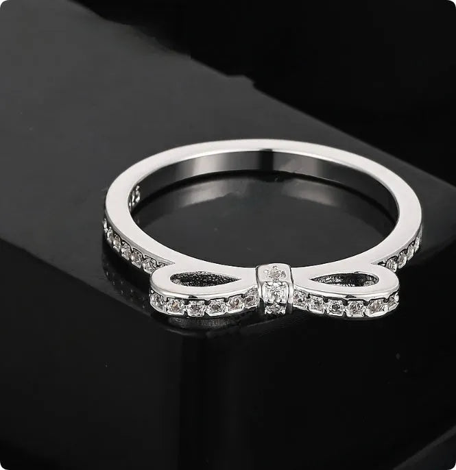 Silver bow ring with rhinestone crystals in couple style band design