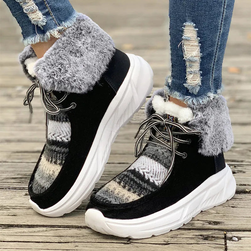 Beige women's lace-up snow boots with a suede upper, thick rubber sole, and plush lining.