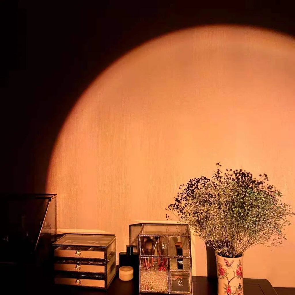Rechargeable sunset red and rainbow projection lamp with USB cable and push-button switch.
