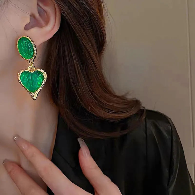 Purple, red, green, and yellow and white alloy pleated oval love heart stud earrings on silver posts.
