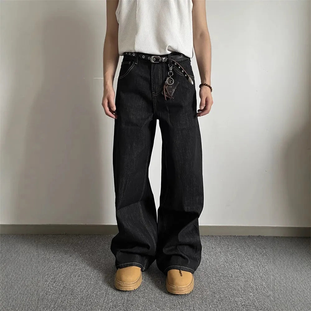 Black loose wide-leg retro jeans with a straight-leg cut and zip fly on a model.