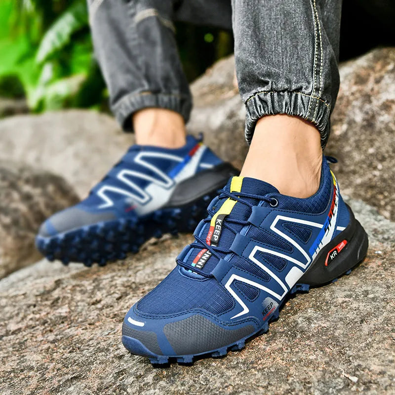 Men's grey orange plus size casual running shoes with low-top design on a plain background.