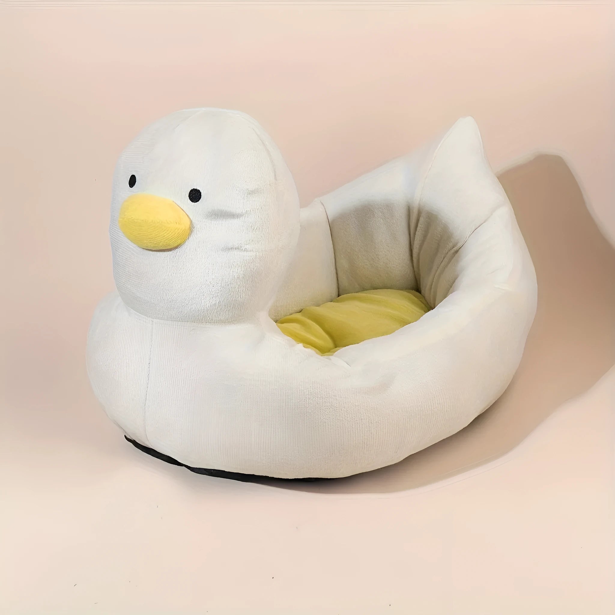 Blue duck-shaped fluffy pet bed for a small dog on a wooden floor.