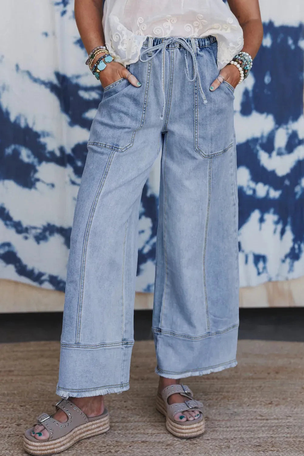 Beau blue wide leg denim trousers with drawstring waistband and raw hem finish